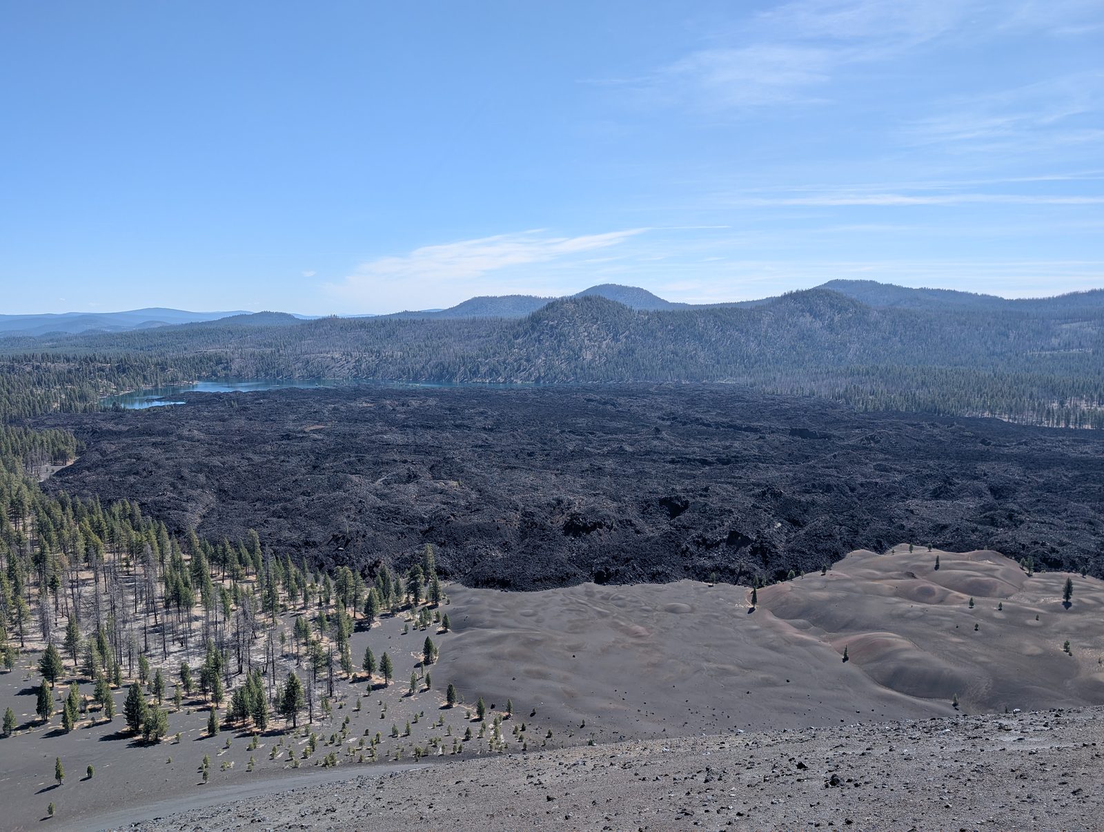 View from the Cinder Cone rim over the surrounding lava flows and forested lakes
