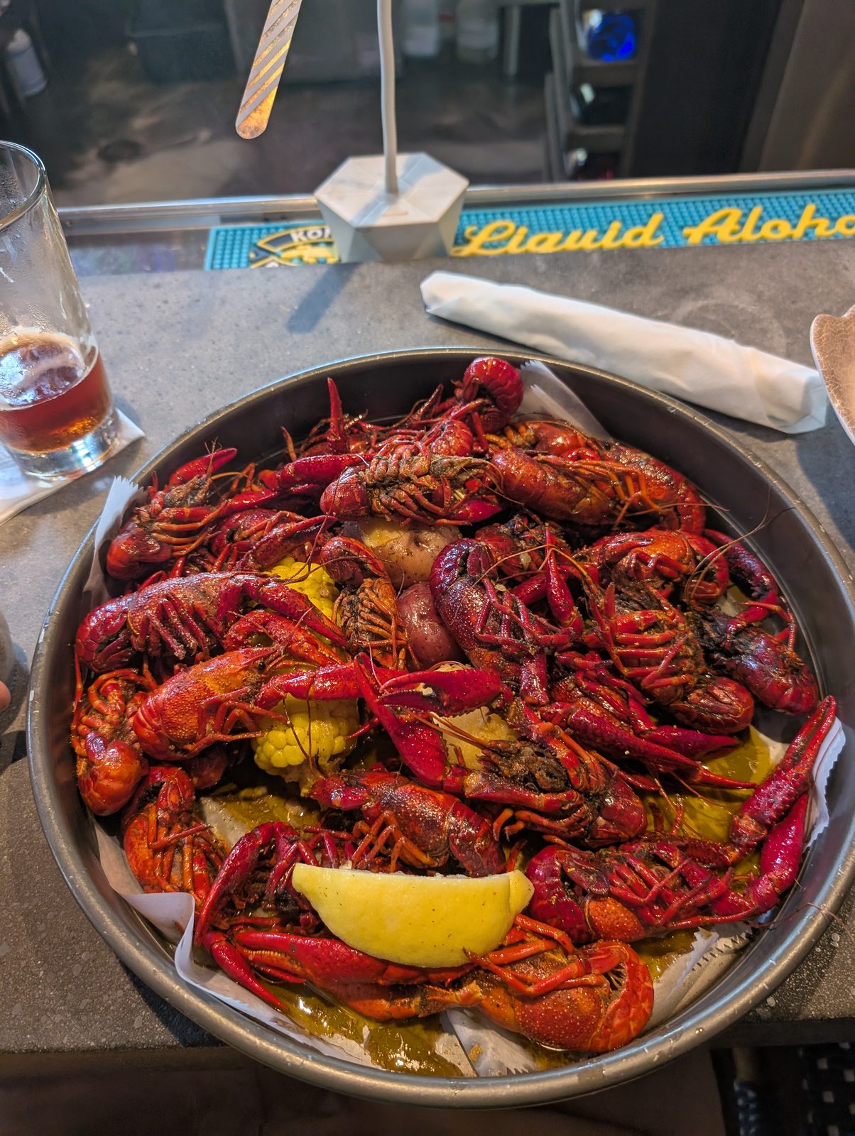A tray of boiled crawfish with corn, potatoes, and lemon at MudBugs Kitchen