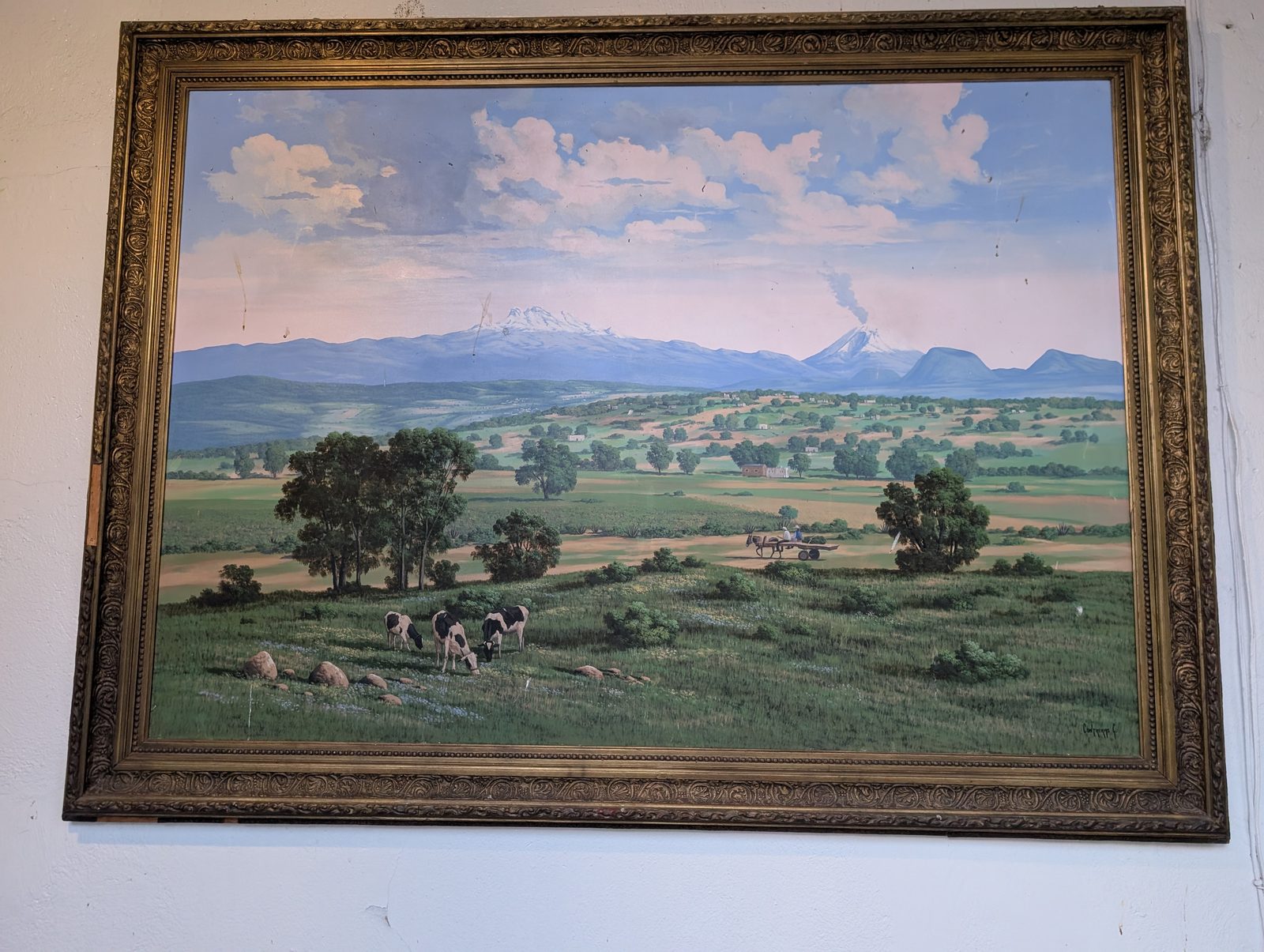 A painting of the Bajío countryside with grazing cattle and smoking volcanoes in the distance